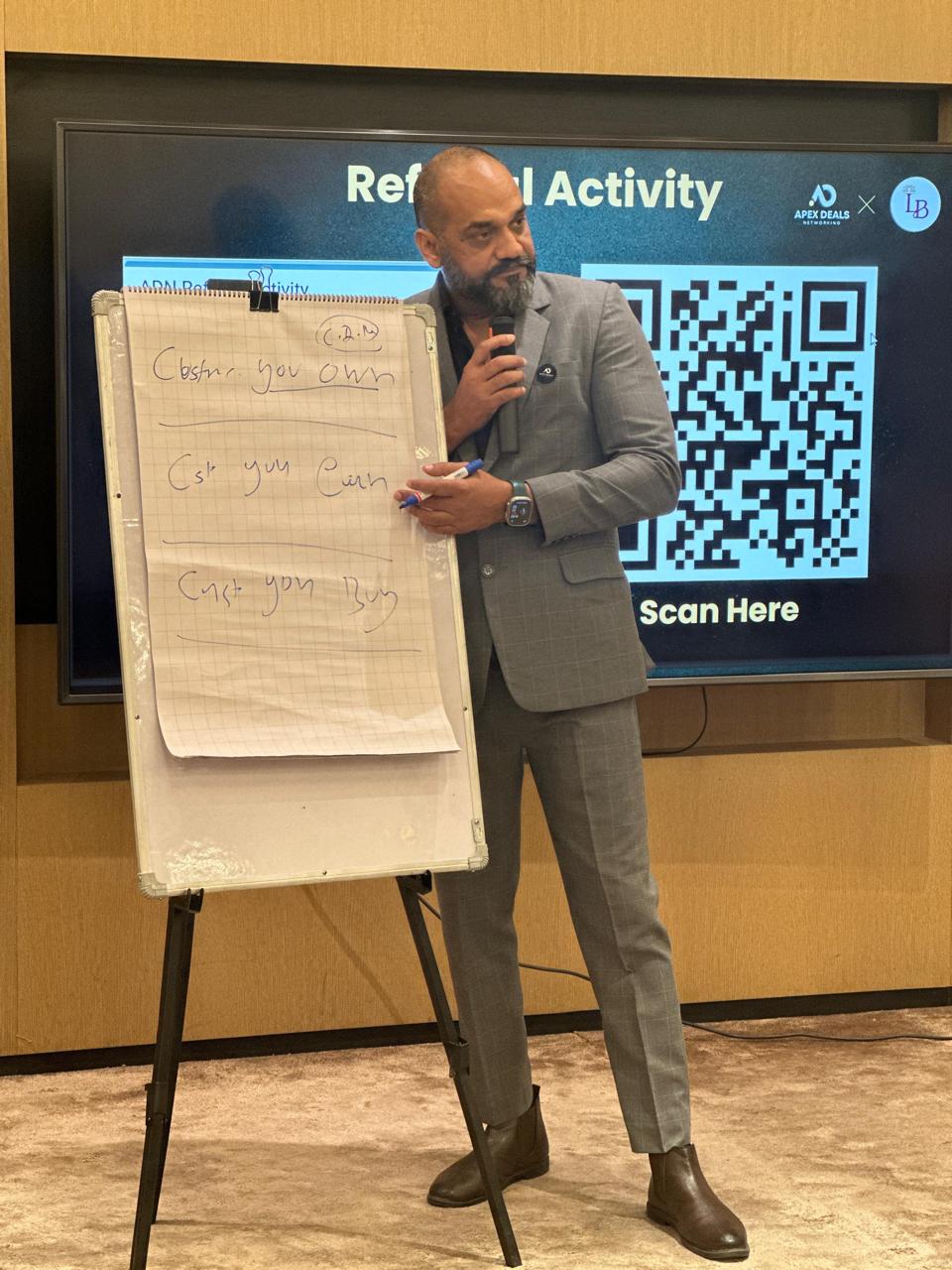 Vijay Sharma running a referral activity workshop with a whiteboard